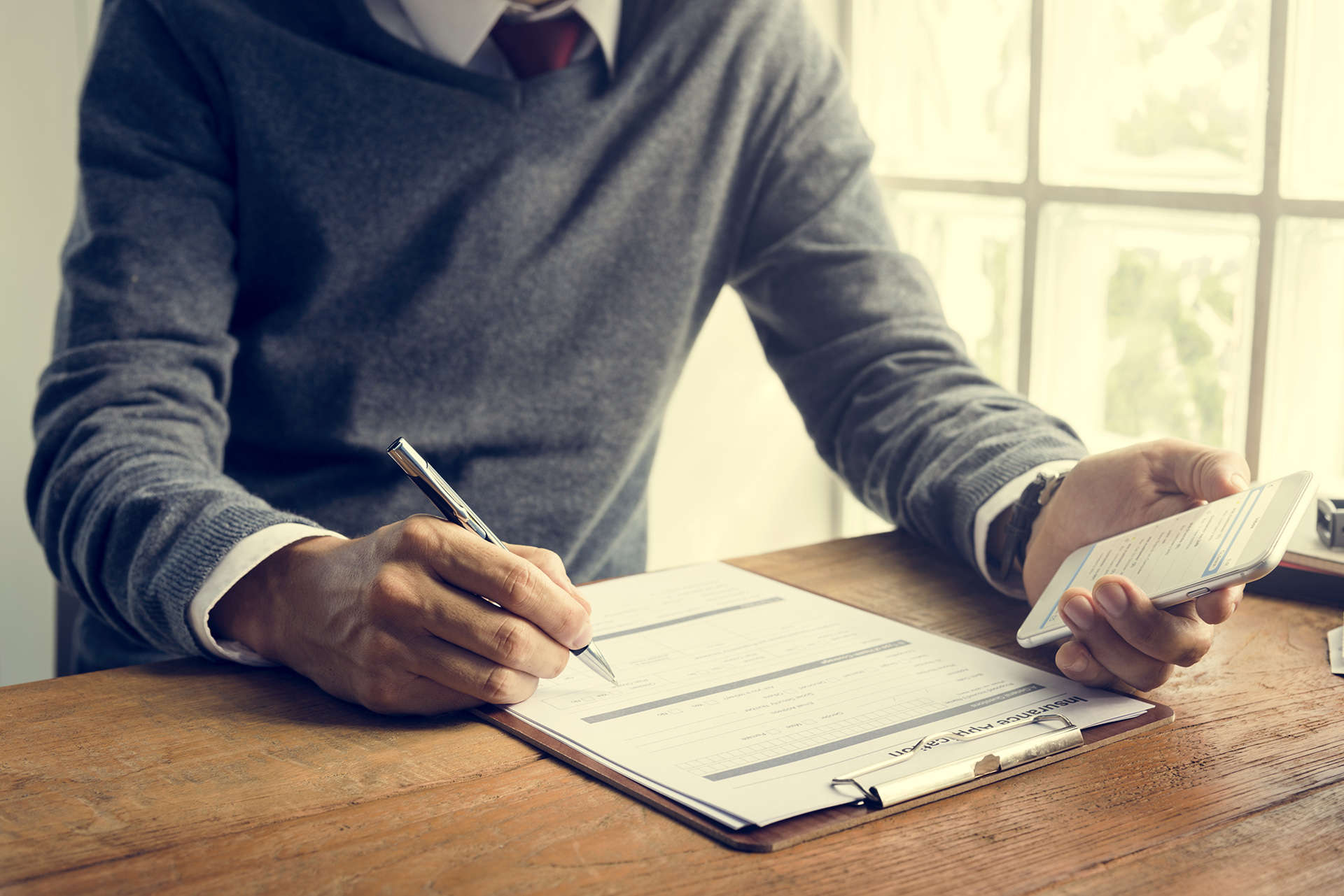 Man Writing Insurance Application Form Concept insurance assistance